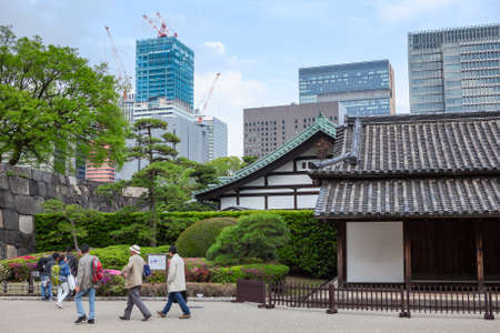 TOKYO, JAPAN - CIRCA APR, 2013: Visitors walk near ancient house of the Hyakunin-bansho Guardhouse. The guardhouse is near the Ote-mon Gate. The East Garden of the Imperial Palaceのeditorial素材