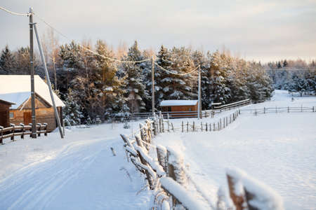Winter with lot of snow in Russian village, rural street in sunset light, Russiaの写真素材