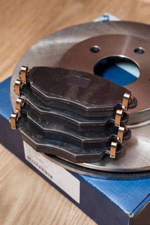 Set of brake pads for front and rear wheel with brake disks with carton box, close upの写真素材