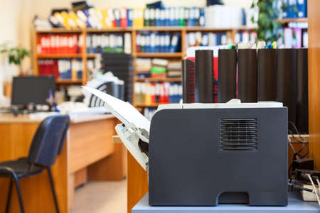 Office supply: printer device is in empty corporate roomの写真素材