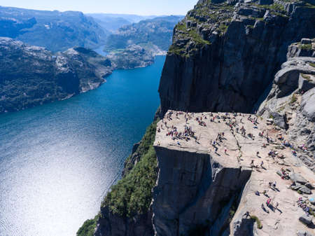 Steep rock Preikestolen over water of fjord Lysefjorden, natural attraction. Top view, flight above cliff. Preacher's Pulpit or Preacher's Chair is in Forsand, Norwayの写真素材