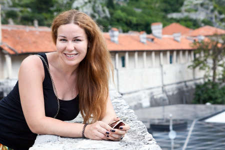 Smiling attractive woman portrait looking at camera, long hair, black shirt, copyspaceの写真素材