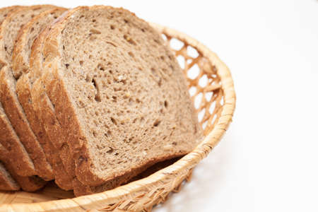Sliced fresh bread in basket plate, isolated on white background