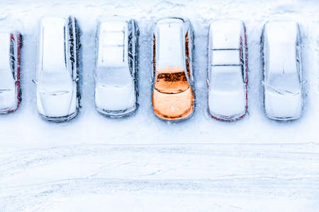 Top view at line from parked cars with one unit warmed up, pre-heating system at winter seasonの写真素材