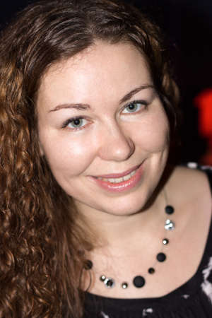 Curly woman portrait, emotional and smiling person looking at camera at party