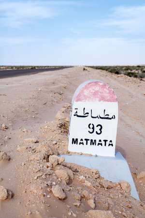 Tunisia, Milepost on a desert road to the Matmata destination, Tunisia, the Africa. Road passing through the salt lake Chott El Djeridの写真素材
