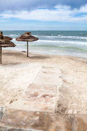 Entry to sea water is on a sandy beach, stormy weather on resort coastline, nobody