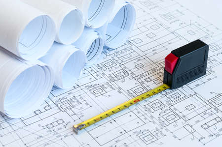 Blueprints and steel tape, drawings for foundation of a building constructionの写真素材