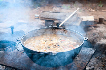 Cauldron with boiled rice, meet, carrot and other ingredients, close-up view pilaff cooking. Rice pilaf cooking seriesの写真素材