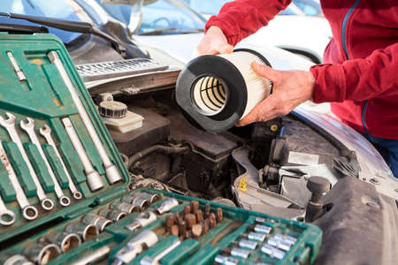 New cartridge of air filter, male hands installing maintenance item, close-up viewの写真素材