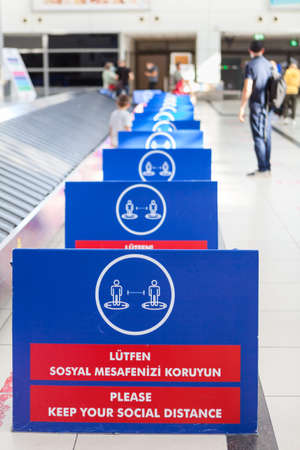 Plastic boards are in luggage area in the Antalya International airport. Signs with notification...