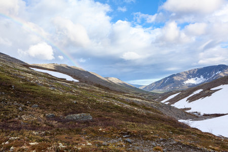 A mountain pass with lot of snow in northern mountains. The Khibins range, Kola peninsula, Russiaの写真素材