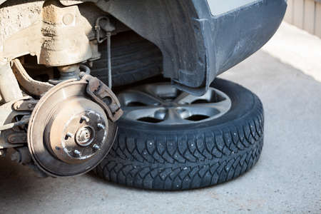 Vehicle tire or break pads repair, inspection and maintenance with removed wheelsの写真素材