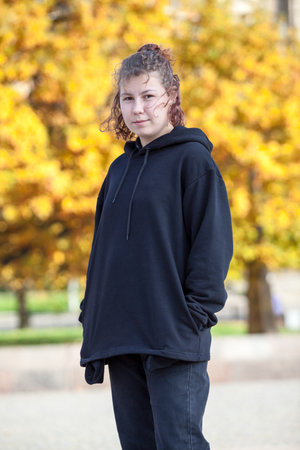 Teen girl portrait wearing black clothes, outdoorsの写真素材