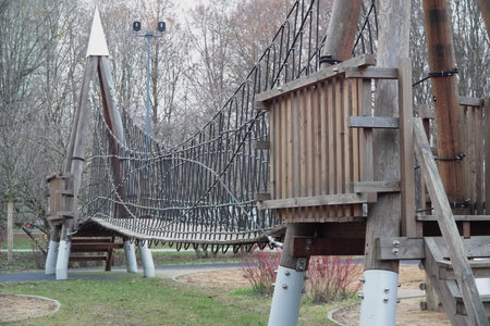 view from below wooden suspension bridge with thick ropes and planks dramatic perspective adventure travel nature outdoor hiking structureの写真素材