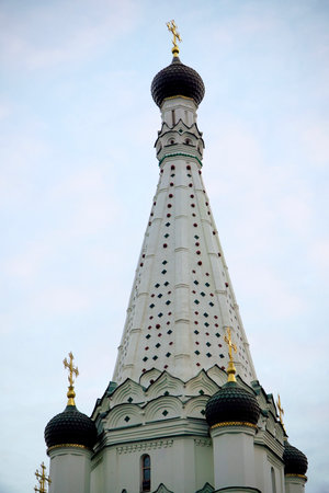 White Orthodox Church with Golden Crosses Against Blue Skyの写真素材