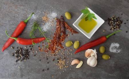 Mediterranean spices and herbs on a stone plateの写真素材