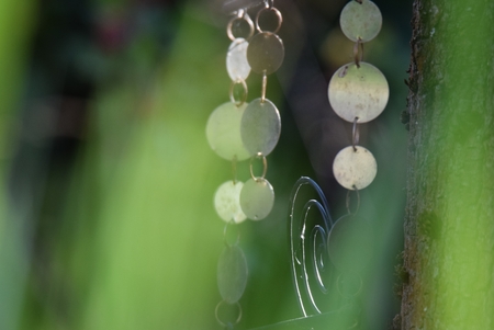 Wind chimes made of metal in the gardenの写真素材