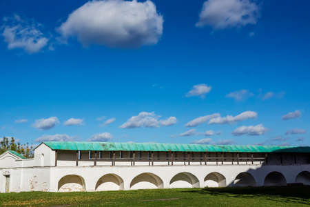 White wall of the monastery against the background of excellent blue sky with cloudsの写真素材