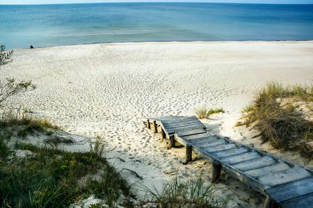 Exit on a wooden ladder to the sea with snow-white sandの写真素材