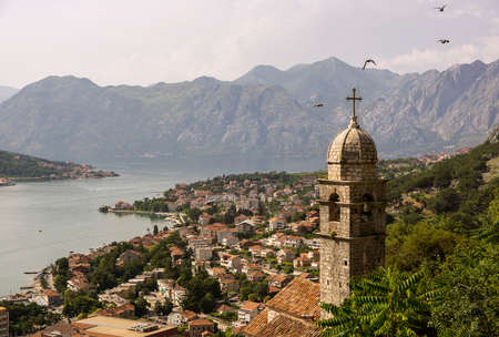 Top view on a city bay and mountains with flying birdsの写真素材