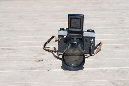 Retro photo camera on wooden surfaceの写真素材