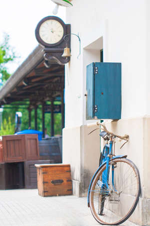 Old blue Bicycle stands at the walls of the building on the platform.の写真素材