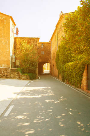 Solar yard. Cozy patio. The European solar yard. Cozy courtyard. Cozy European Sunny courtyard. The building with the arch. The road leading through the yardの写真素材