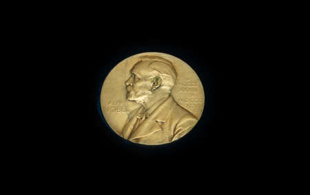 The medal is awarded annually to the prestigious international Nobel prize. Gold medal on black backgroundの写真素材