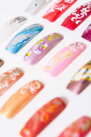 Beautiful colorful false nails on a light background. Nail things. The designs on false nailsの写真素材