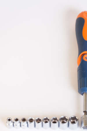 A set of heads for the car on a light background. Metal adapter under the nut. Cropped image to fit...