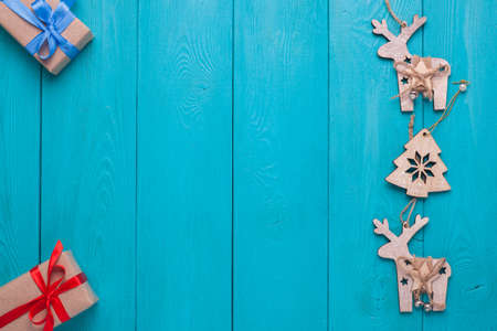 Turquoise background for Christmas cards. Background for Christmas wishes. Blue wooden planks. Christmas card. Christmas gifts. Holiday gift. Christmas deer.の写真素材