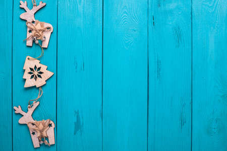 Turquoise background for Christmas cards. Background for Christmas wishes. Blue wooden planks. Holiday gift. Christmas deer.の写真素材