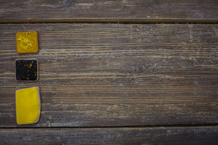 Yellow-and-black mosaic on the table. The texture of wood and ceramics. Colorful designs and patterns on ceramic products.の写真素材