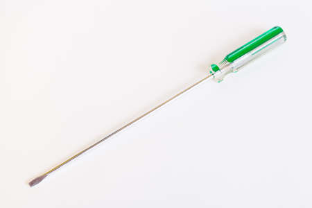 Screwdriver with a long rod. Transparent green handle screwdriver with flat tipの写真素材