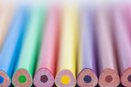 Colored pencils in a blurred form. The image is blurred. A set of colored pencils. Selective focus. A place for a label.の写真素材