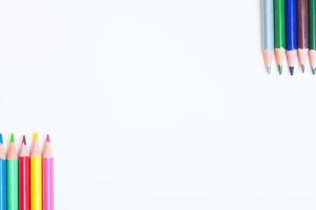 Colored pencils on a light background. The tips of the pencils are positioned in the corners on white background with space for inscriptions. White box for your text with pencilsの写真素材