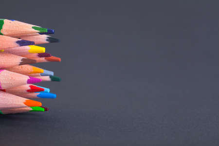 Pencils on grey background with space for inscriptions. The tips of pencil leads on the left frame and the right space for text.の写真素材