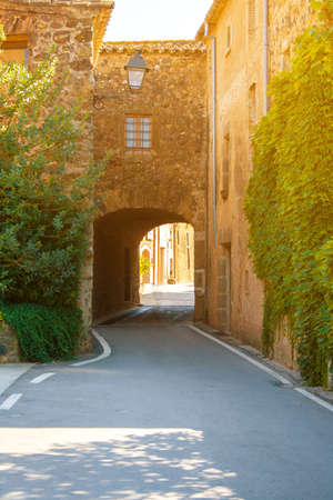 Sunny courtyard. A cozy patio. European Sunny courtyard. Cozy European Sunny courtyard. The building with the arch.の写真素材