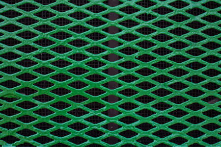 Green mesh. The green background. Painted metal surface. The lattice texture as a background...