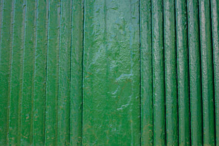 Green grille. The green background. Painted metal surface. The lattice texture as a background element. Metal painted green. The vertical parallel lines of the grilleの写真素材