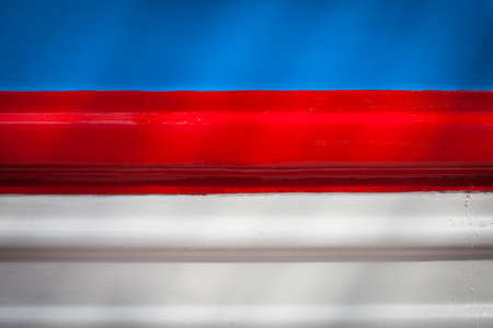Paint smudges on the surface. The colors of the flag of the Russian Federation. Metal painted in the Russian tricolor. Parallel horizontal lines. Blue, red, white colorの写真素材