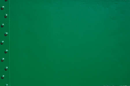 The green background. Painted metal surface. Metal surface connected by rivets. Metal painted green. For background on advertisingの写真素材