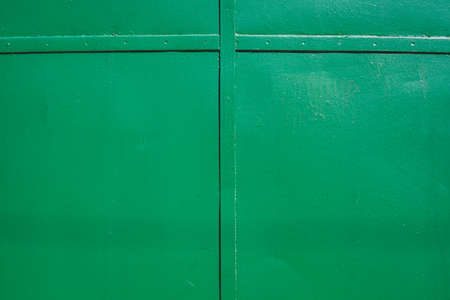 The green background. Painted metal surface. Metal painted green. Iron plates welded togetherの写真素材