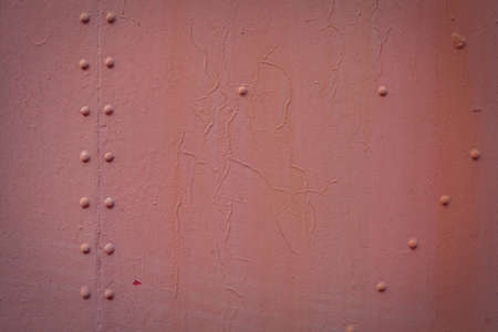 The red background. Painted metal surface. The surface of the train as a background element. Paint...