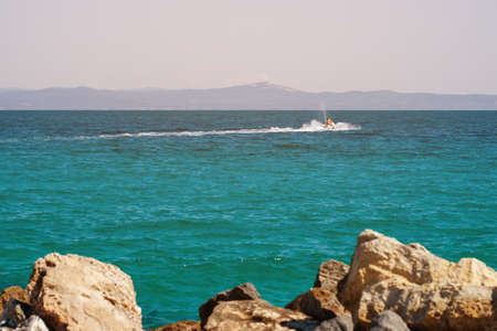 Jet ski racing on the waves of the Bay. Entertainment in the resort towns. Jet ski on the Mediterranean sea.の写真素材