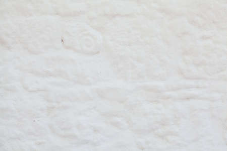 Texture of white stone background. The surface is plastered and painted in light color.