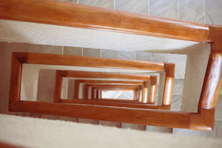 Stairs spiral curls deep down. The tunnel from the stairwell. Perspective of stair railings in the...