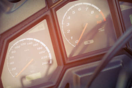 The speedometer and tachometer in the glare of the sun. The red arrows on the odometer at zero. Devices in control panel the motorcycle.の写真素材
