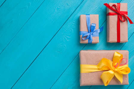 Gifts are on the bright wooden planks. Place the graphic on a turquoise background. Top view of...